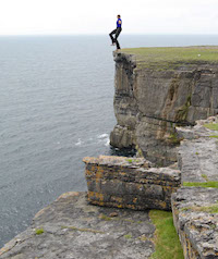 Man standing on the edge of a cliff.